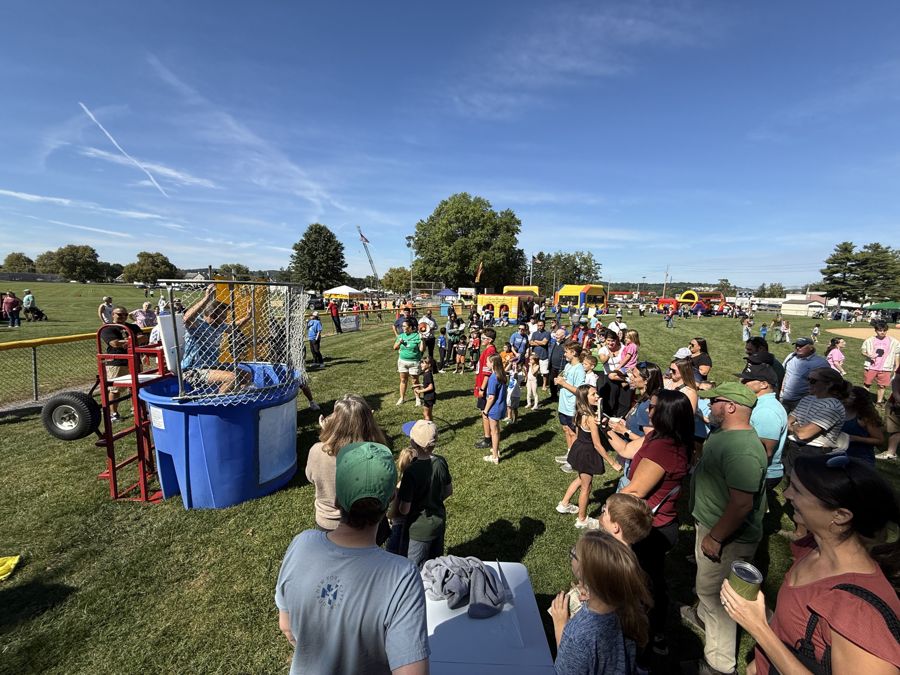 Crowd gathered around the dunk tank at Community Day 2026