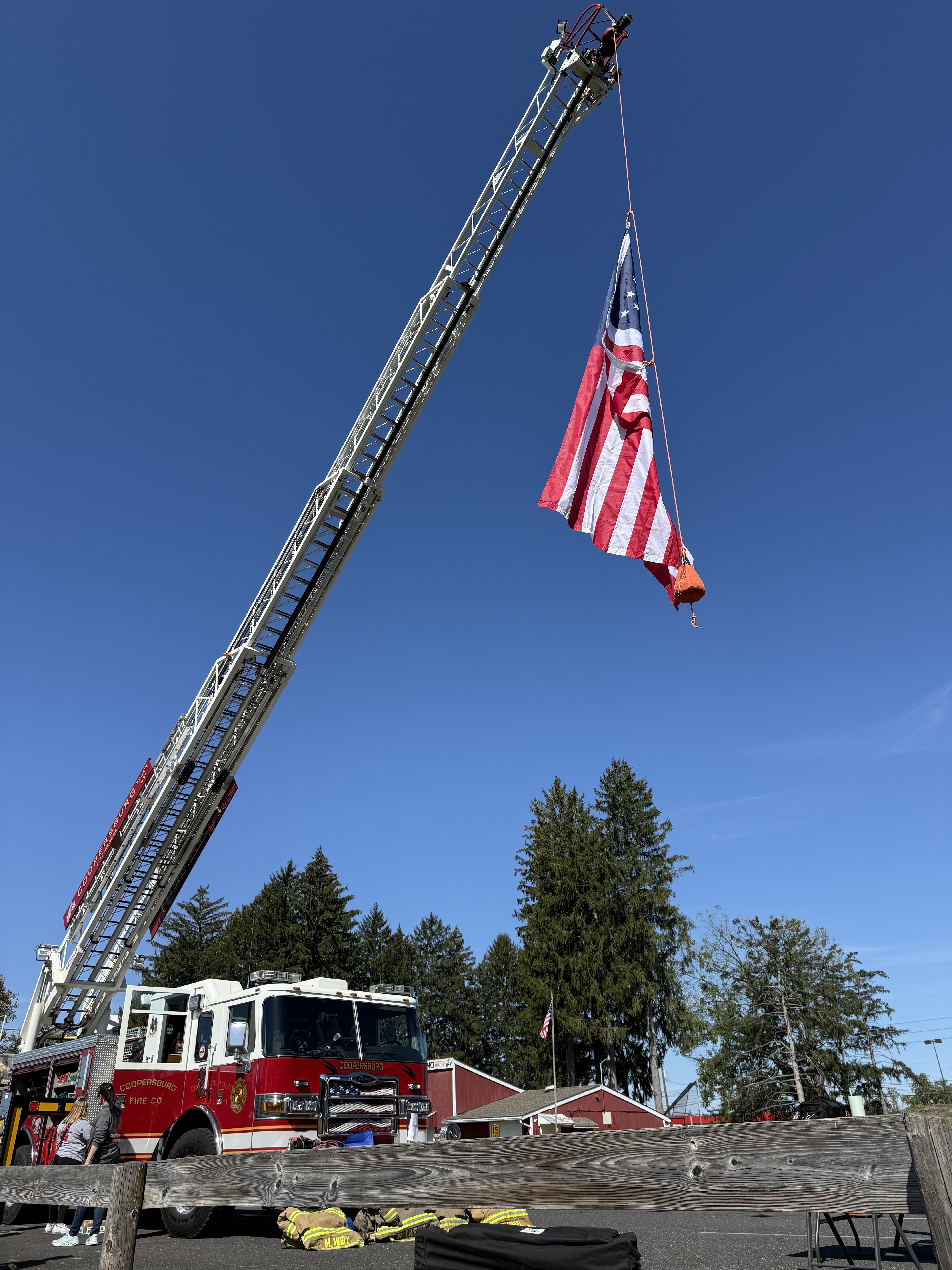 Coopersburg Fire Company ladder truck raising the American flag at Community Day opening ceremony