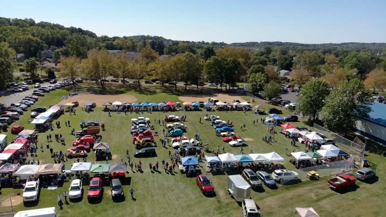 Aerial view showing the full scale of Coopersburg Community Day 2025 — classic cars, vendor tents, and thousands of attendees