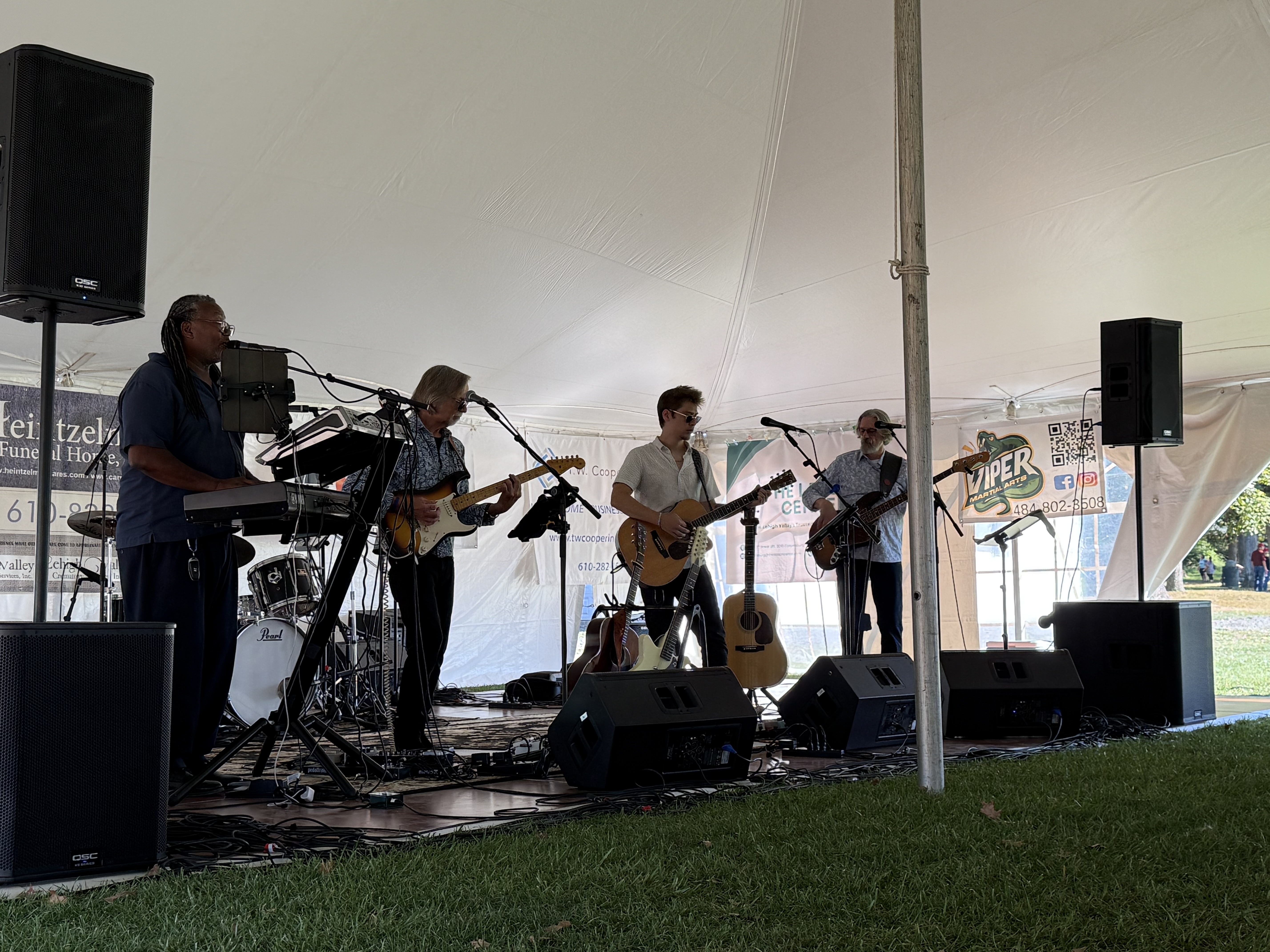 Live band performing under the entertainment tent at Coopersburg Community Day